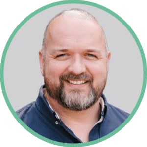 Headshot of Paul Howe, teal circle around the image